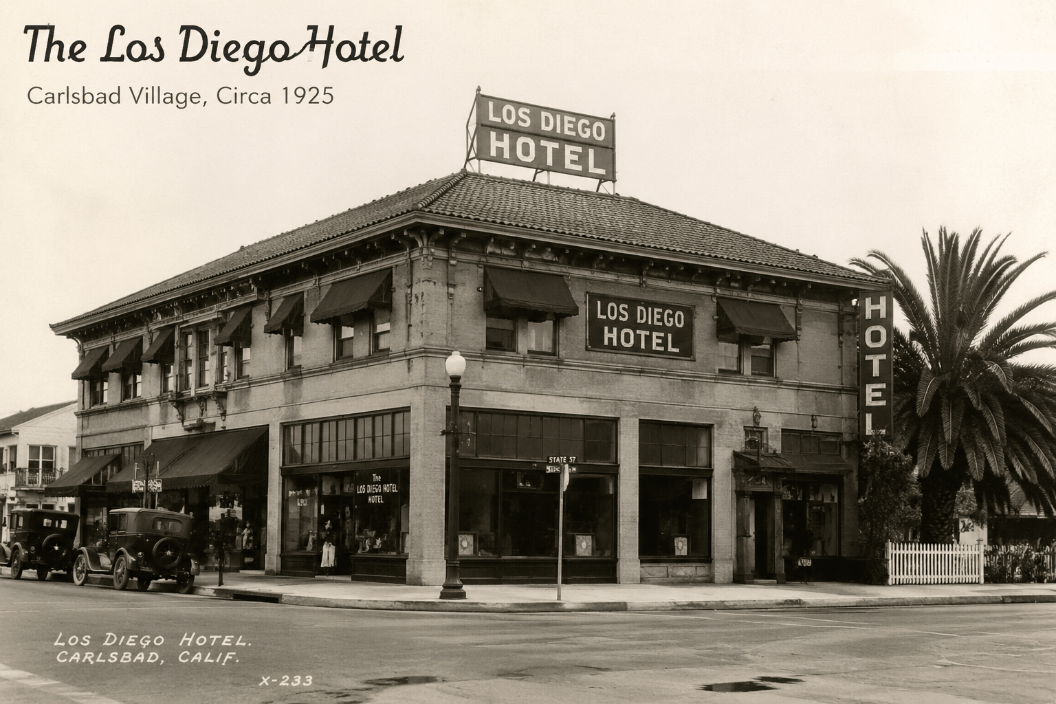 Vintage photo of Los Diego Hotel, Carlsbad, circa 1925, with cars and a palm tree.