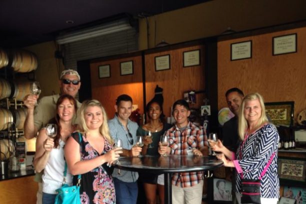 a group of people holding wine glasses