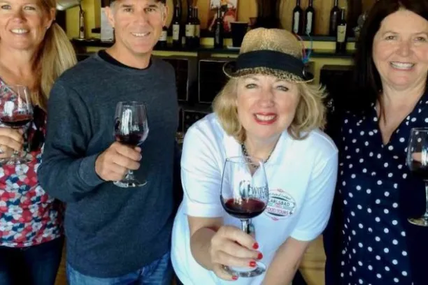 a group of people holding wine glasses