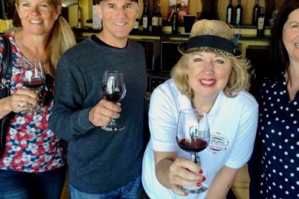 a group of people holding wine glasses