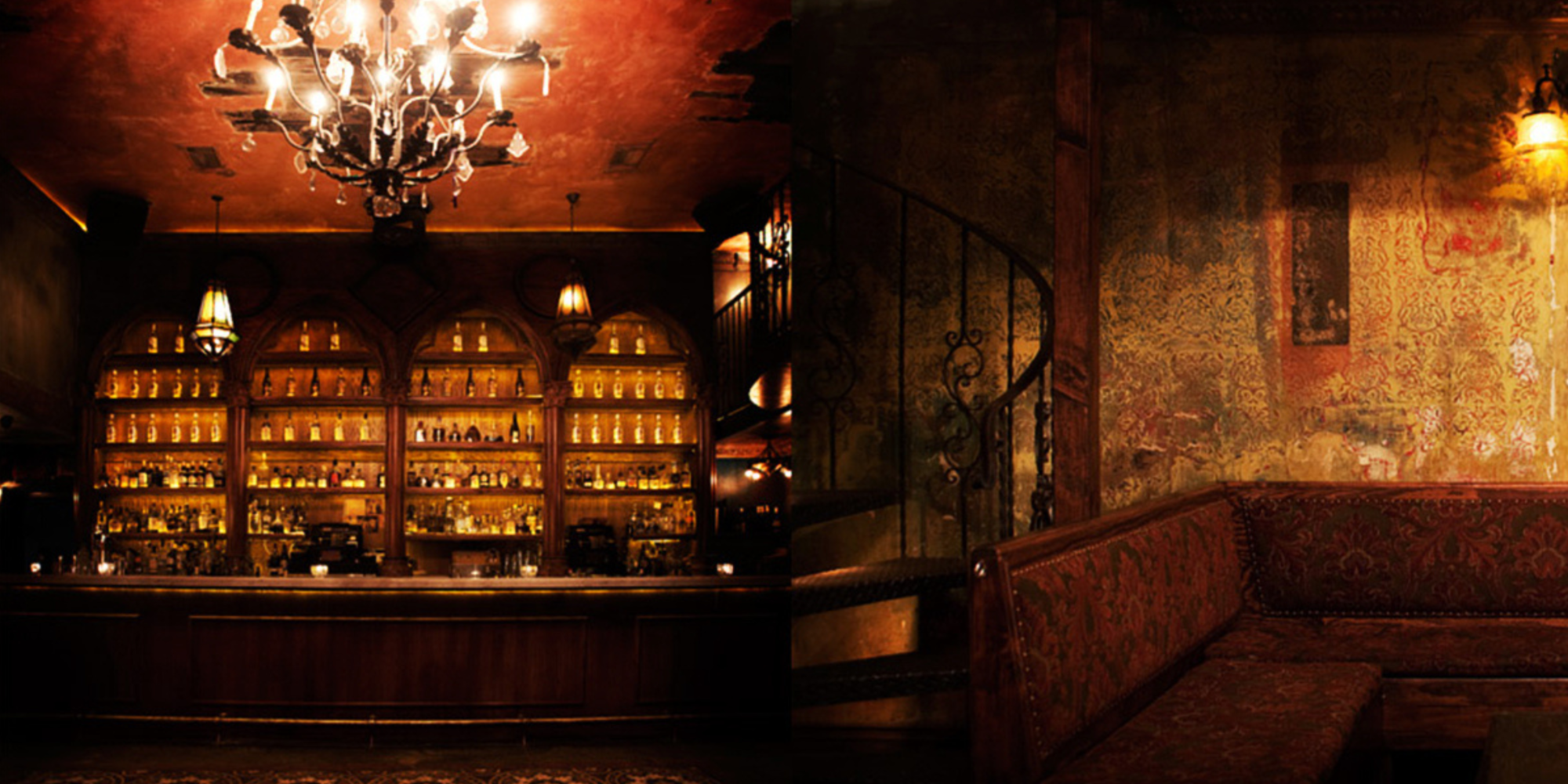 Dimly lit vintage bar with chandelier, ornate shelves, and cozy seating area.
