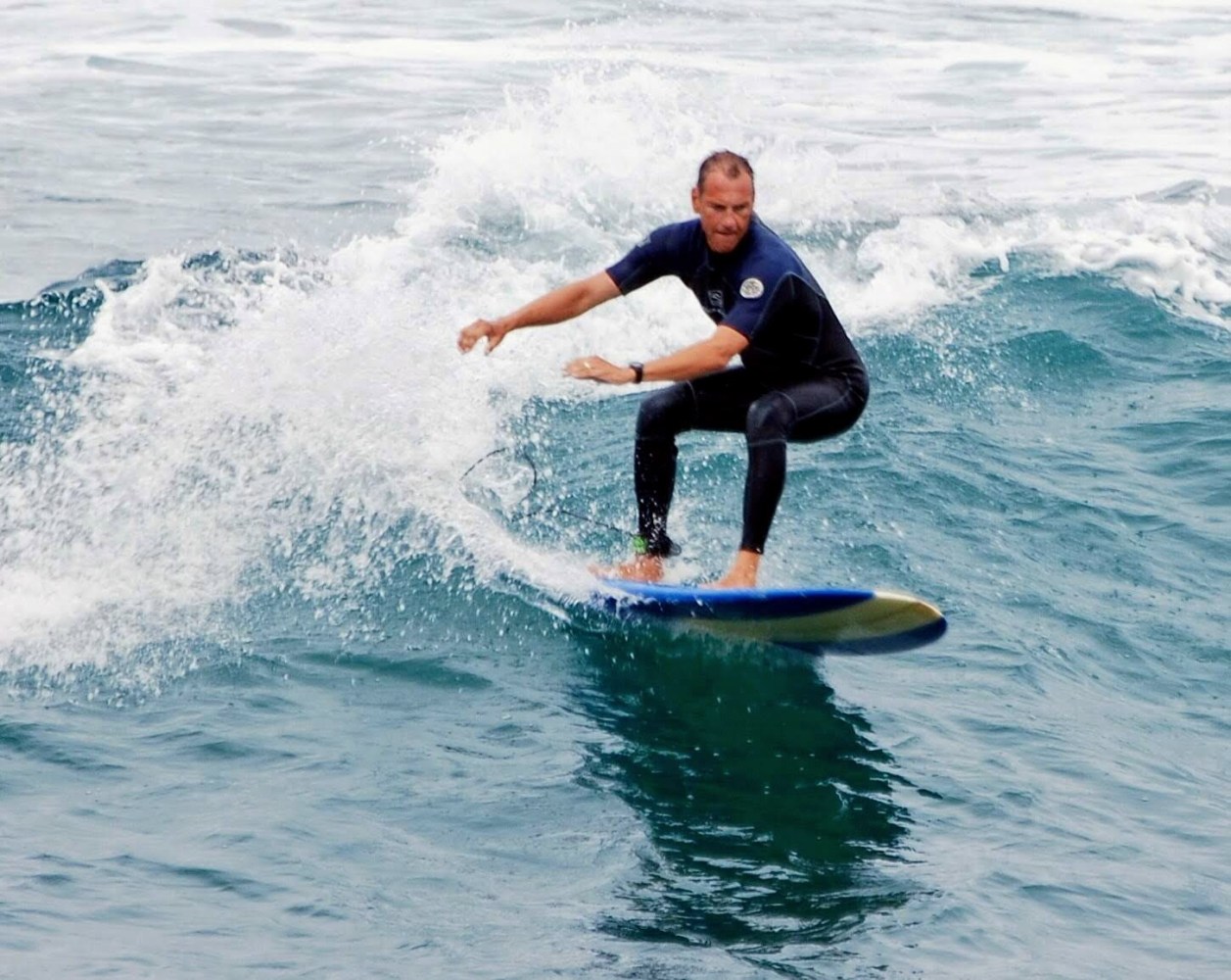 a man riding a wave on a surfboard in the ocean