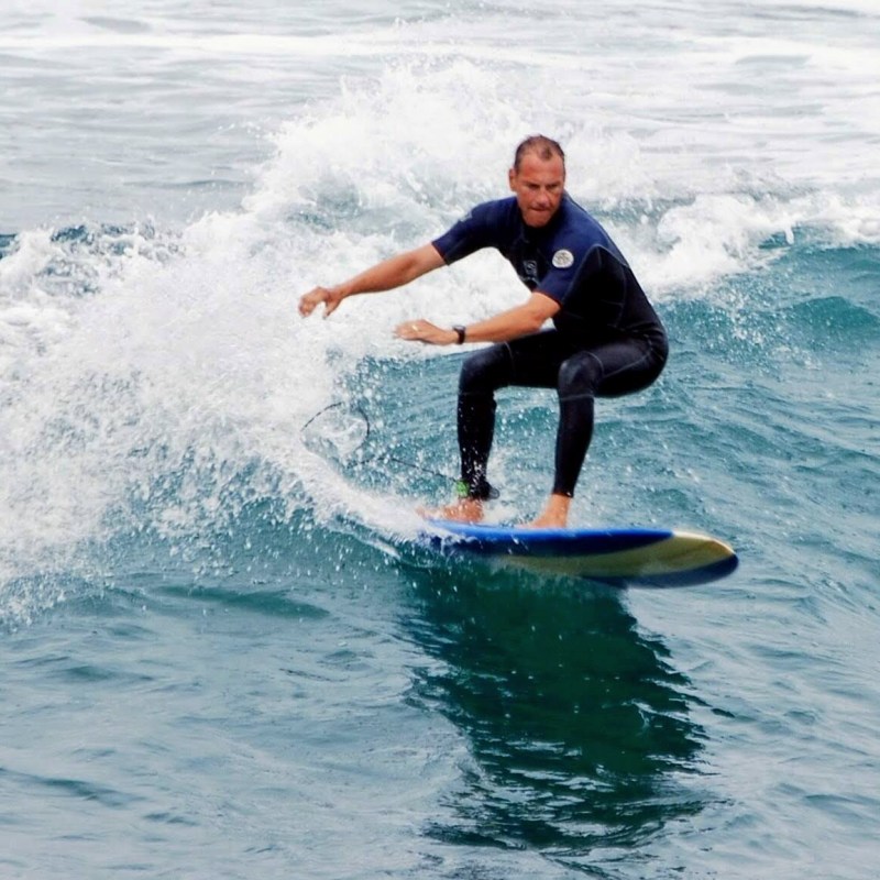 a man riding a wave on a surfboard in the ocean