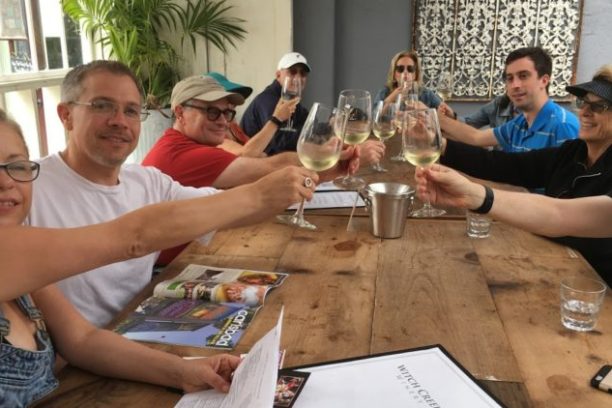a group of people sitting at a table with wine glasses