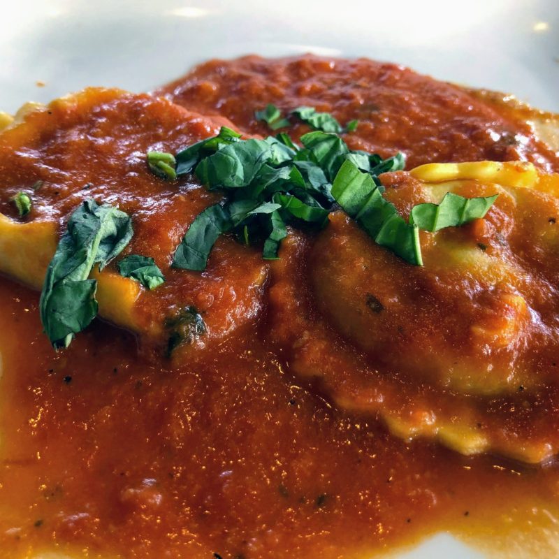 a close up of a plate of food with a slice of pizza