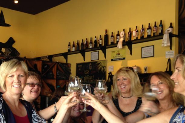 a group of people sitting at a table with wine glasses