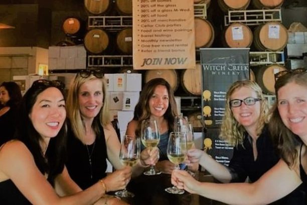 a group of people holding wine glasses
