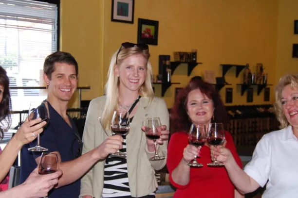 a group of people sitting at a table with wine glasses