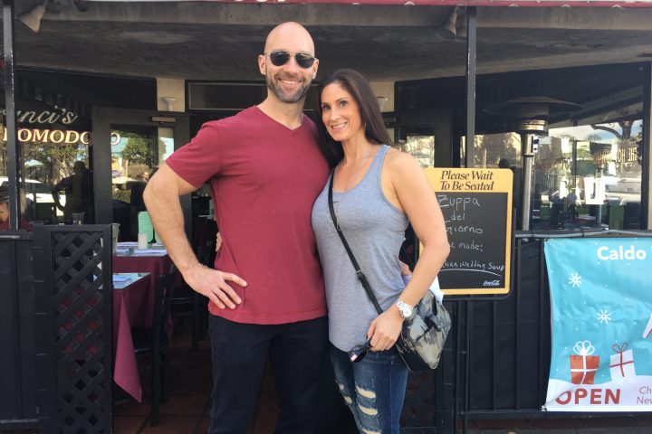 a man and a woman standing in front of a store