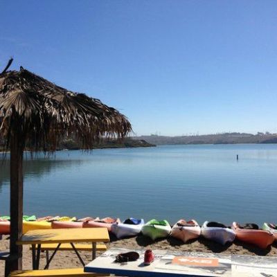a group of lawn chairs sitting on top of a body of water