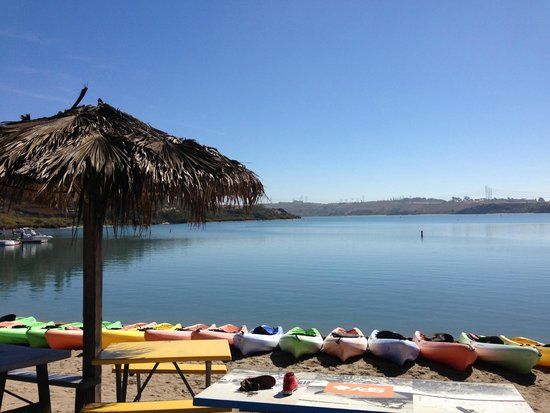a group of lawn chairs sitting on top of a body of water