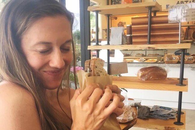 a woman sitting at a table eating food