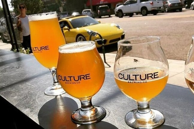 a glass of orange juice next to a cup of coffee