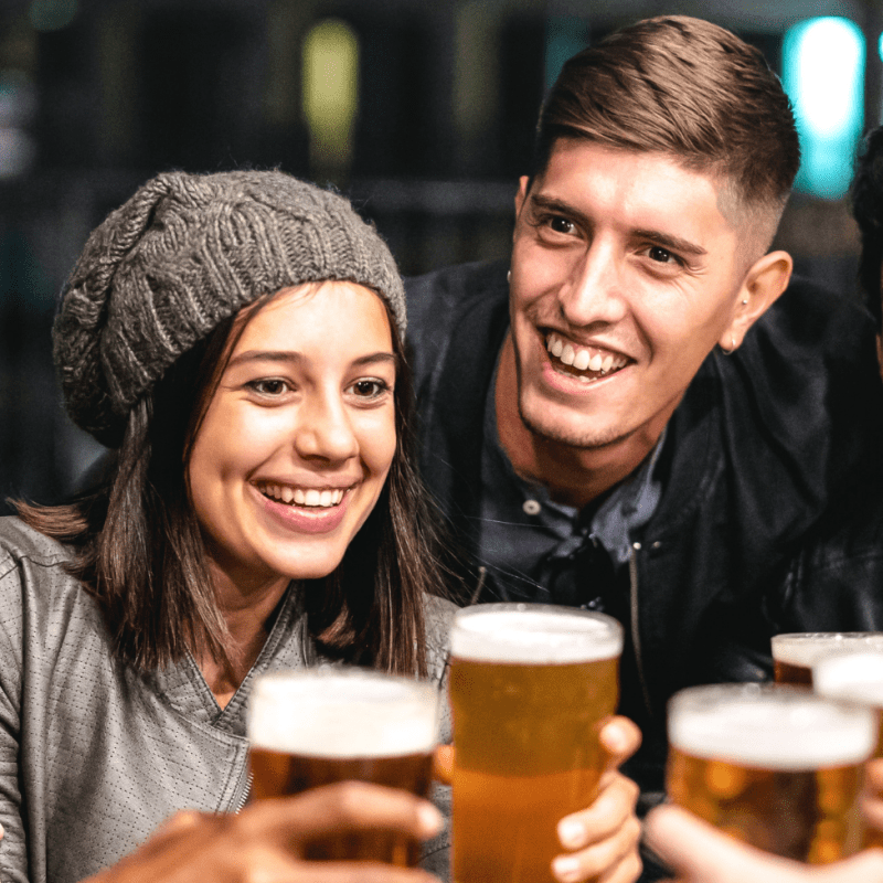 a group of people sitting at a table with a plate of food