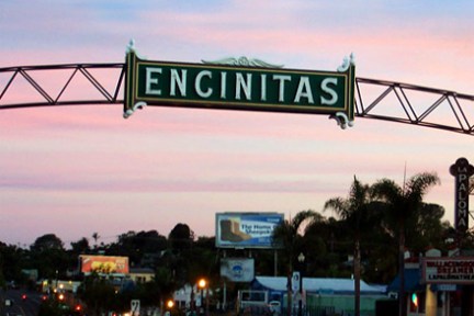 a street sign hanging off the side of a bridge