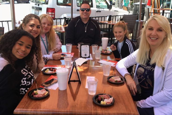 a group of people sitting at a table in a restaurant