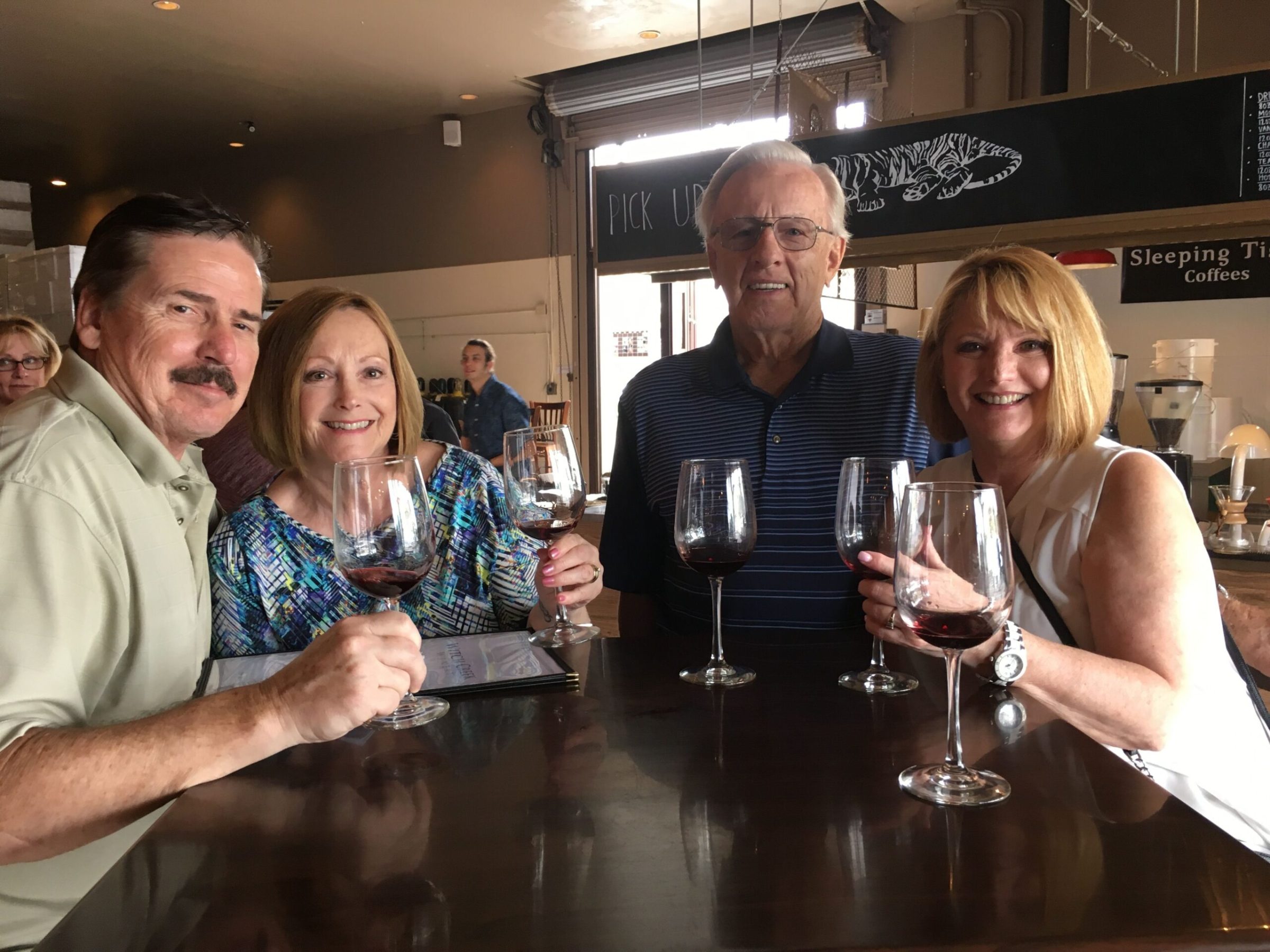 a group of people holding wine glasses