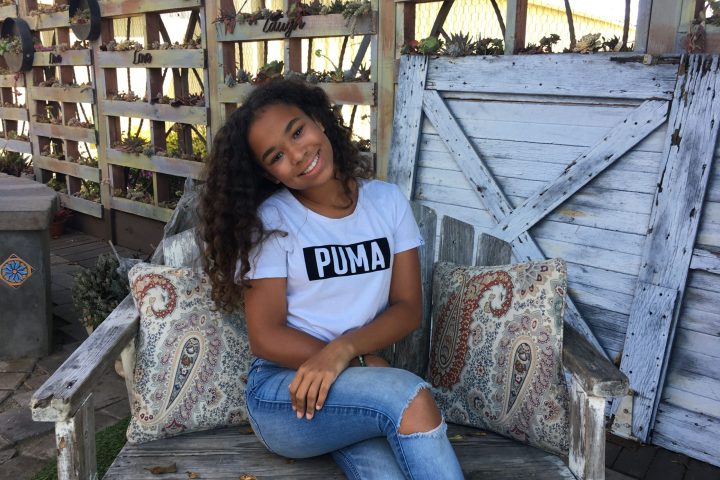 a girl sitting on a bench