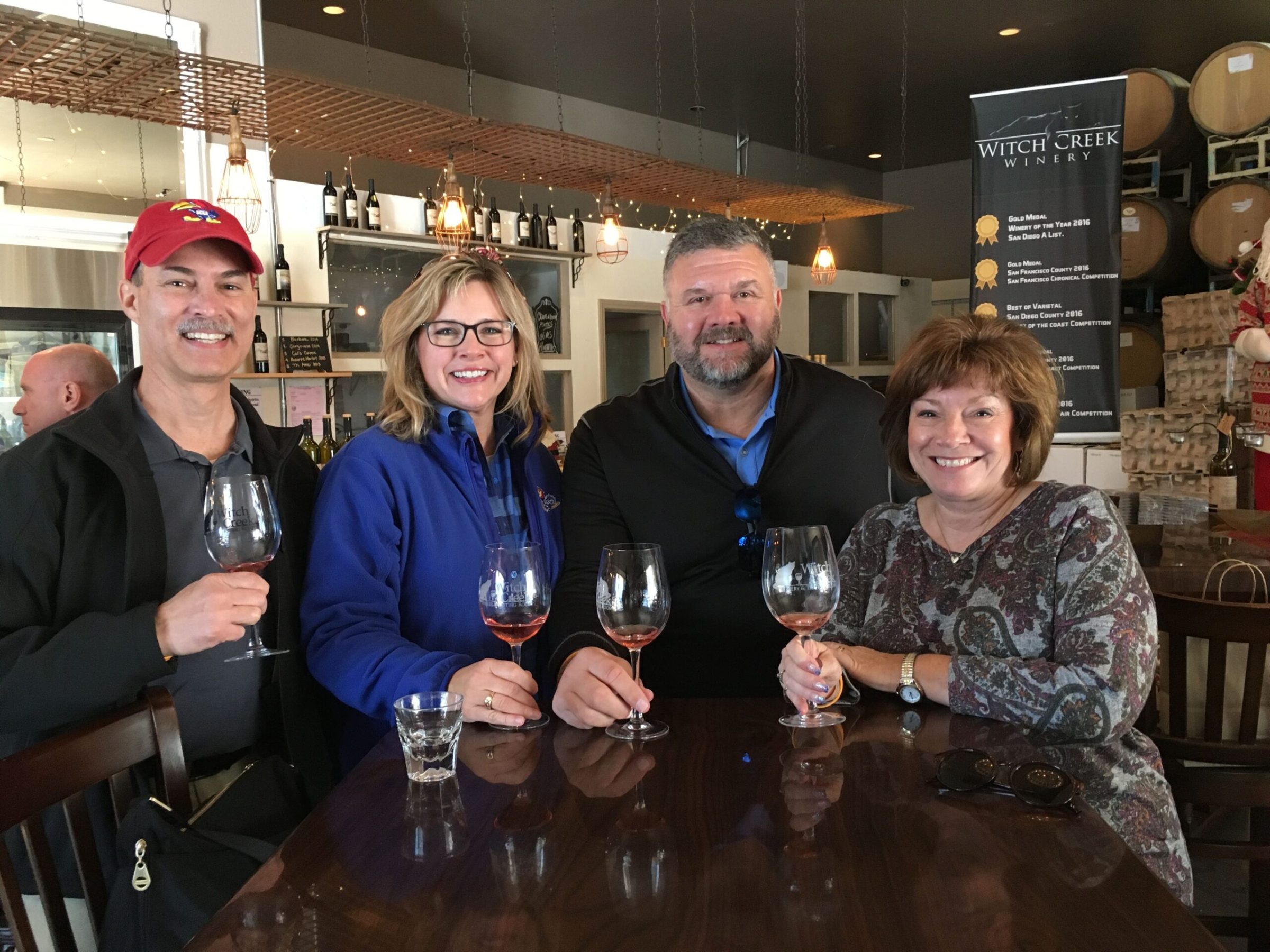 a group of people sitting at a table with wine glasses