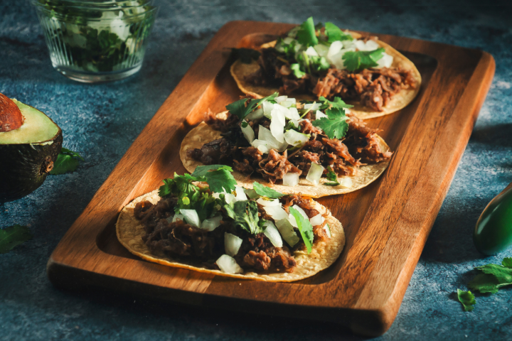 a slice of pizza sitting on top of a wooden cutting board