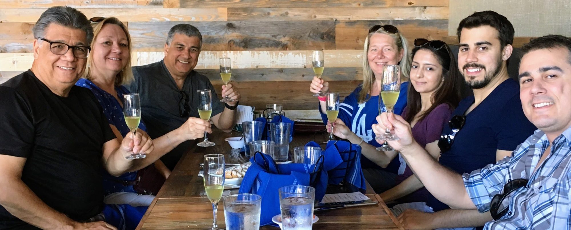 a group of people sitting at a table with wine glasses