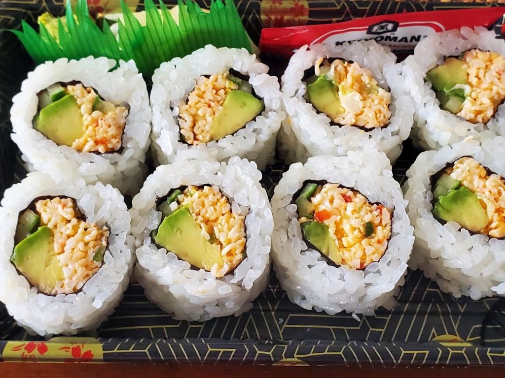 a plastic container filled with sushi