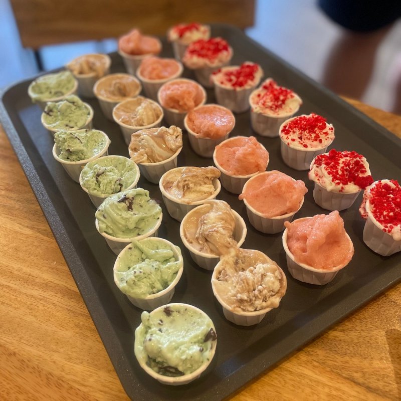 a wooden cutting board with a cake on a table