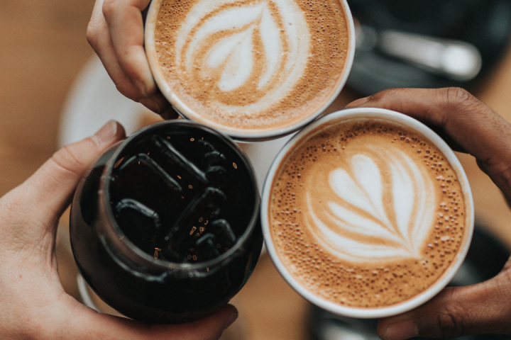 a person holding a cup of coffee