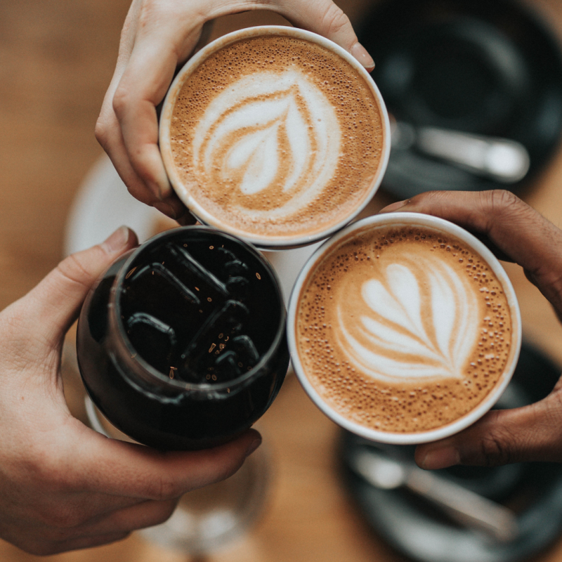 a person holding a cup of coffee
