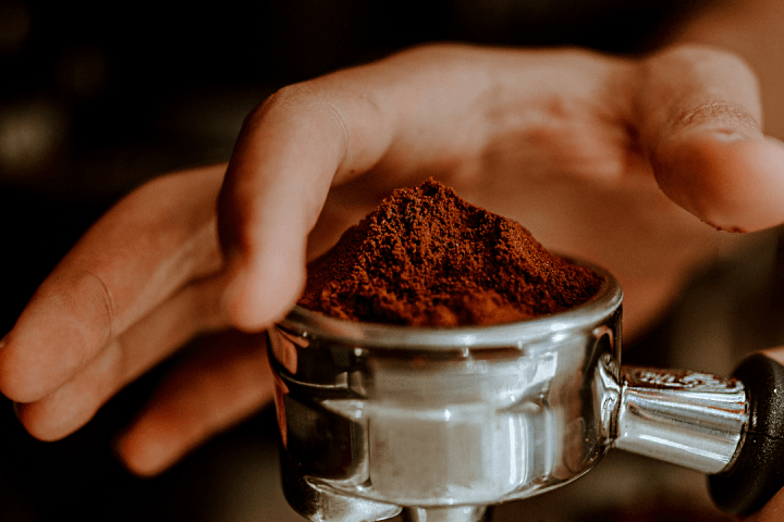 a close up of a person holding a cup