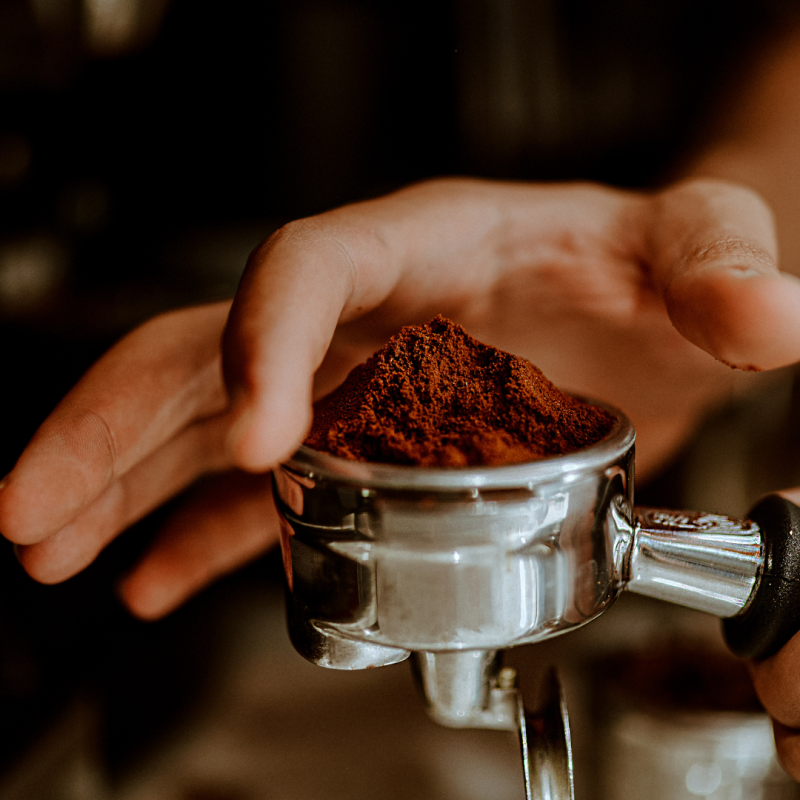 a close up of a person holding a cup