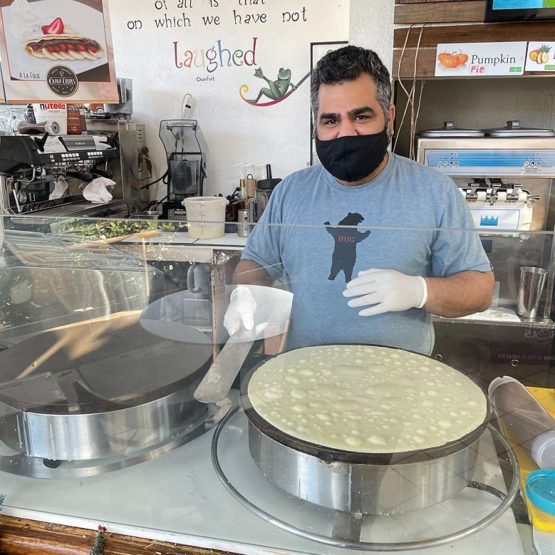 a man cooking in a kitchen preparing food