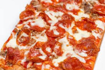 a pizza sitting on top of a cutting board
