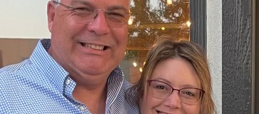 a man and woman posing for the camera