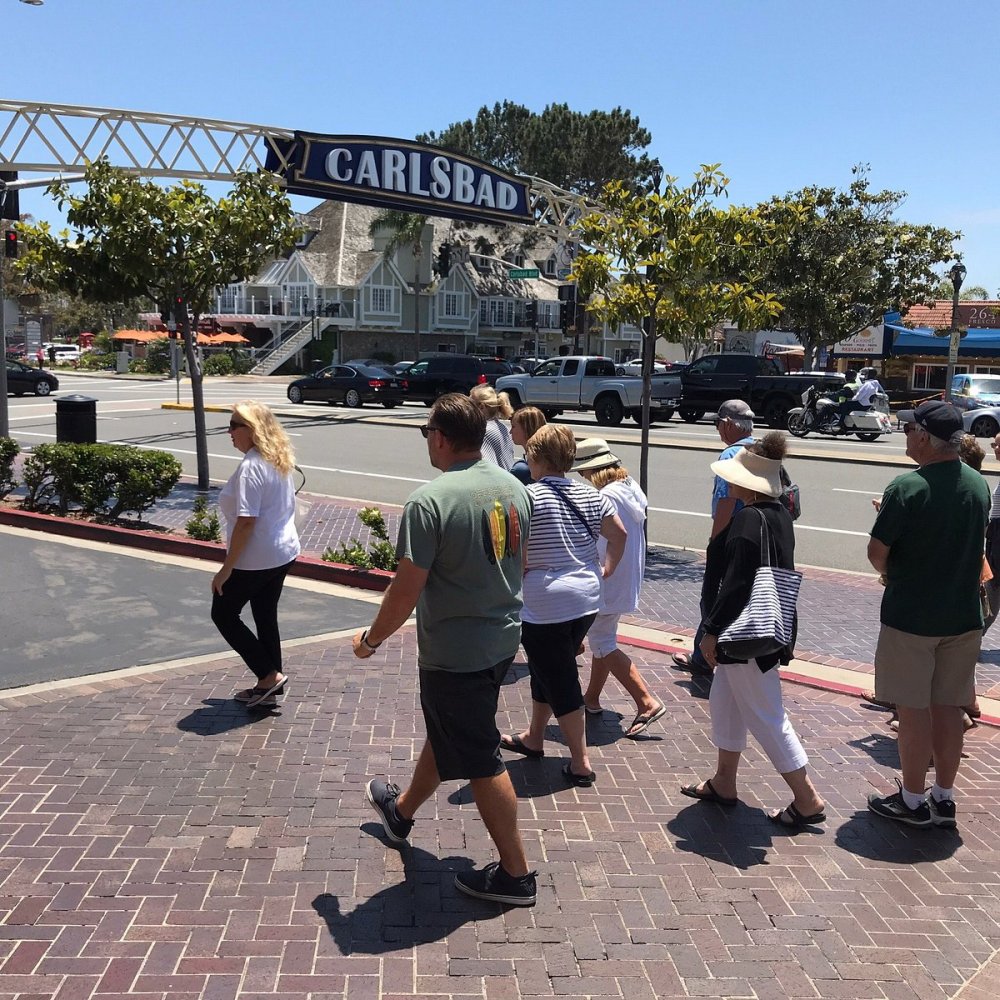 a group of people standing in a parking lot