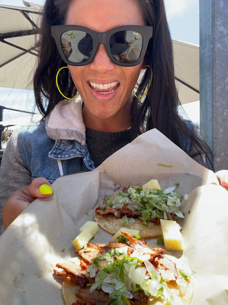 a woman holding a piece of food