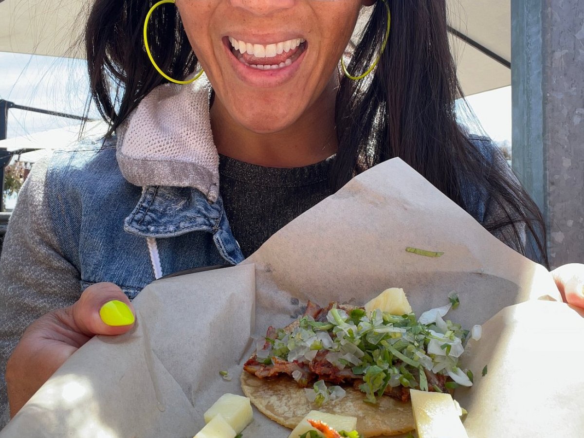 a woman holding a piece of food
