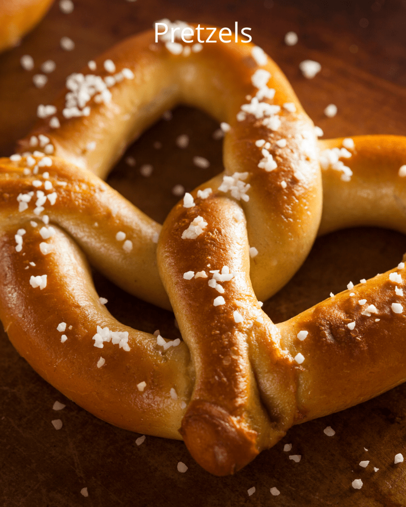 Close-up of salted pretzels on a wooden surface with text 'Pretzels'.