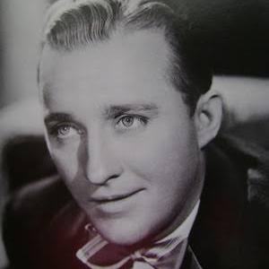 Black and white portrait of a man with slicked-back hair wearing a bow tie.