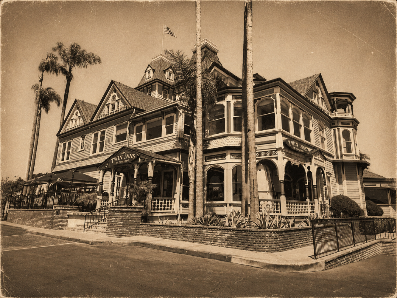Vintage photo of a large, ornate Victorian-style house with palm trees.