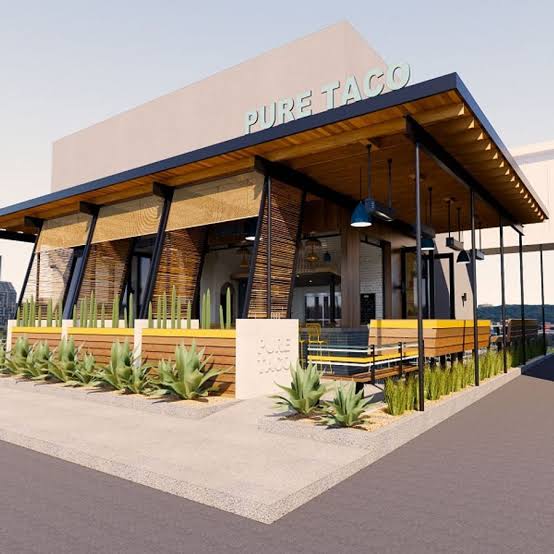 Modern taco restaurant with large windows and outdoor seating area.