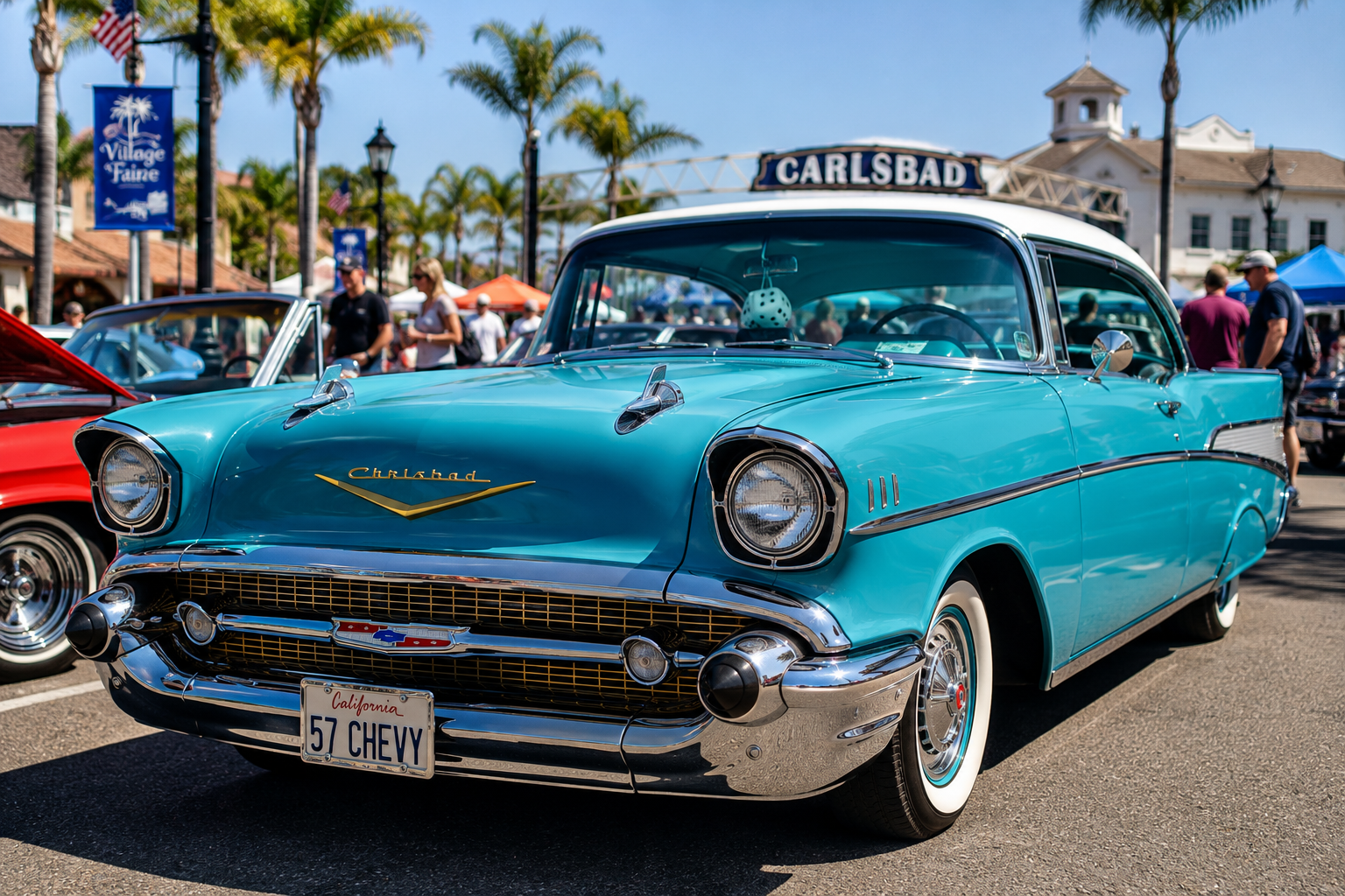 Turquoise 1957 Chevy car displayed at a car show with palm trees in the background.