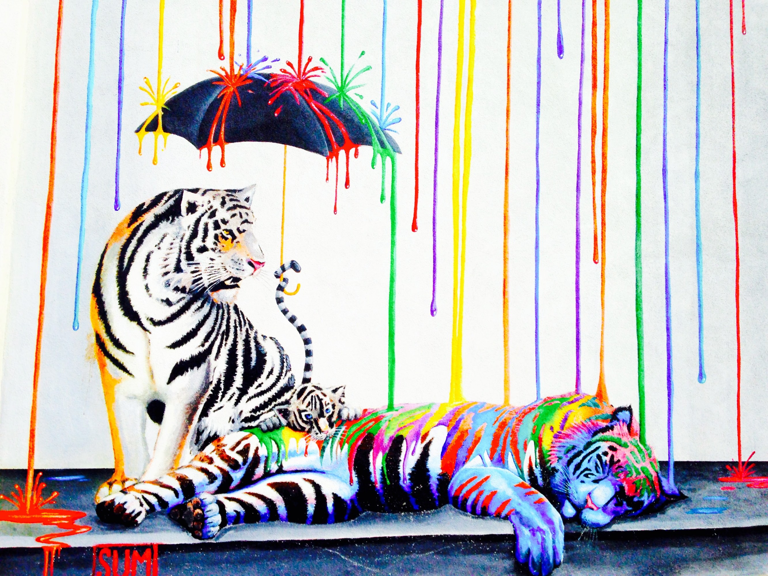 Two tigers with rainbow stripes, one standing, one lying down, under a black umbrella with colorful drips.