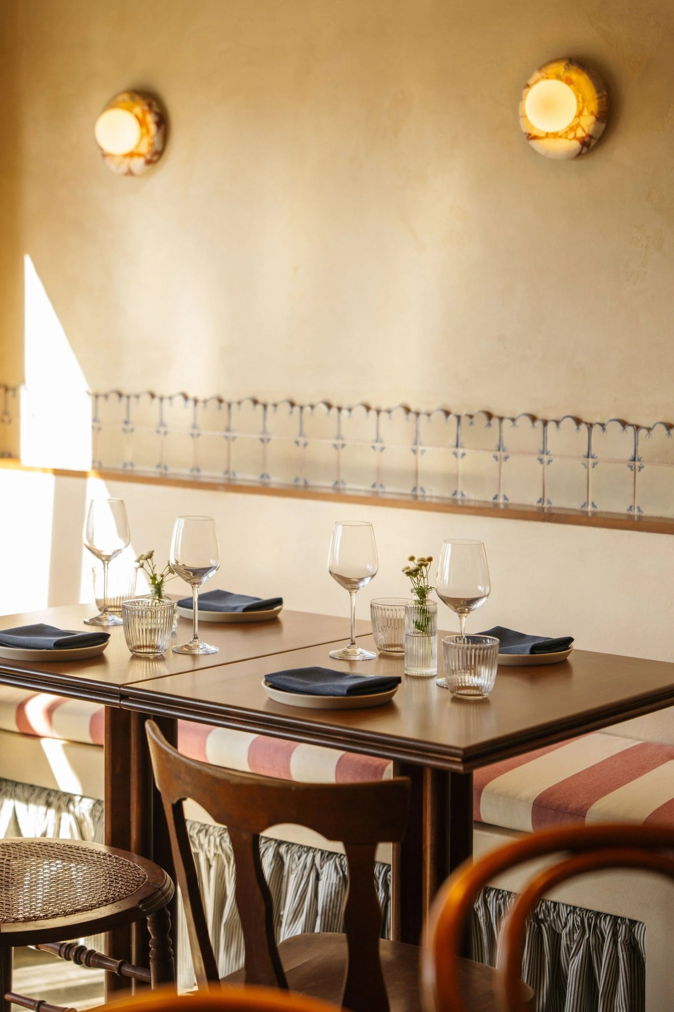 Cozy restaurant setting with neatly set tables and warm lighting.