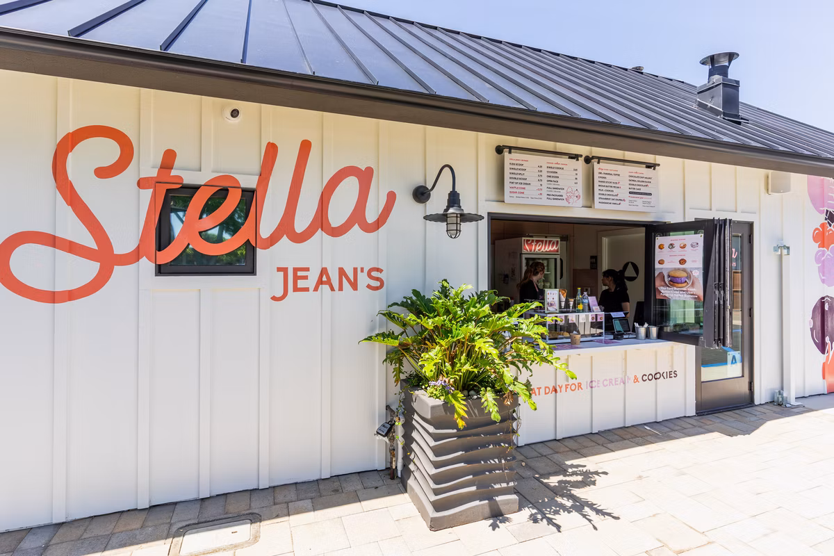 Ice cream shop with 'Stella Jean's' sign and potted plant outside.