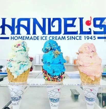 Three colorful ice cream cones in front of Handel's Ice Cream sign.